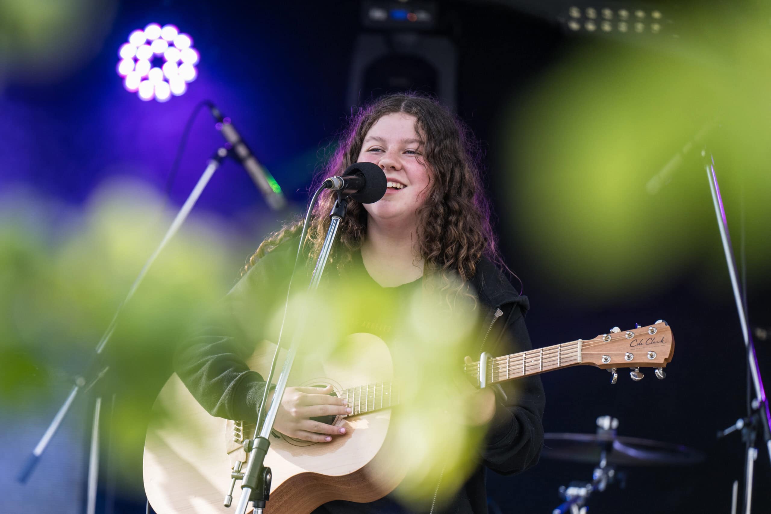 Young girl on stage with a guitar